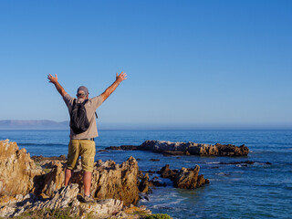 Older man celebrating life, success and happiness. Hermanus. Whale Coast. Overberg. Western Cape. South Africa