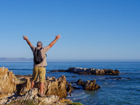 Older Man Celebrating Life, Success And Happiness. Hermanus. Whale Coast. Overberg. Western Cape. South Africa