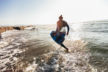 Surfer man with surf board on the beach. Summer sport activity