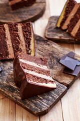 Chocolate cake on a wooden table. Side view