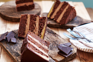 Chocolate cake on a wooden table. Side view