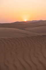 Landscape of desert dunes at sunset