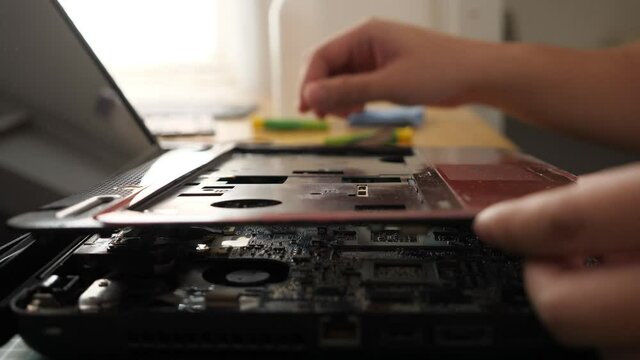 Close up of technician engineer trying to repairing broken laptop. Computer repairs and upgrade