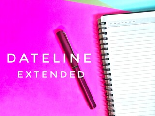 Dateline extended. Written on a pink paper with a note book and a pen.