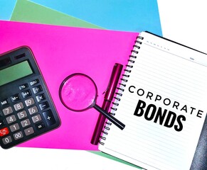 Corporate bonds wording on a note book with a magnifying glass, calculator and a pen on colorful A4 paper background.