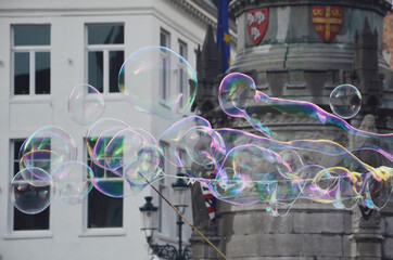 Soap bubbles floating in the air with background of Bruges town.