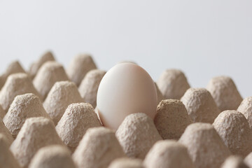 One egg white in a paper box, top view.
