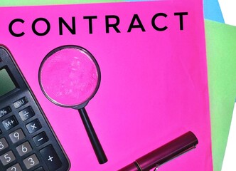 Contract. Written on a pink paper with a magnifying glass, calculator and a pen.