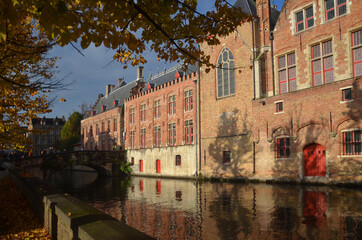 Naklejka premium Autumn in Bruges, Belgium. Bruges, the capital of West Flanders in northwest Belgium, is distinguished by its canals, cobbled streets and medieval buildings.