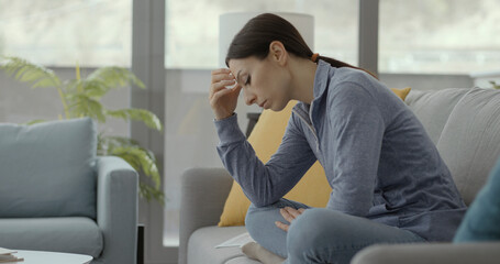 Sad lonely woman staying at home during the coronavirus pandemic