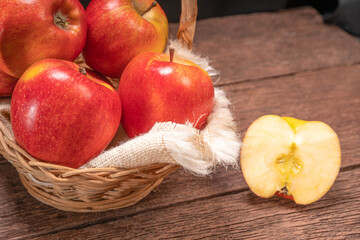 Envy Apple In a basket on a wooden floor.