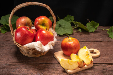 Envy Apple In a basket on a wooden floor.