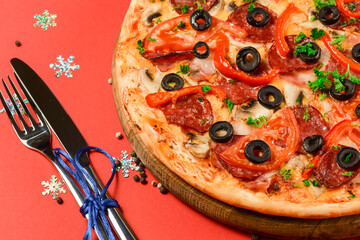 Christmas Pizza on a red background. Isolated. Flat lay, top view.