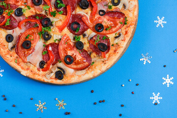 Christmas Pizza on a blue background. Isolated. Flat lay, top view.