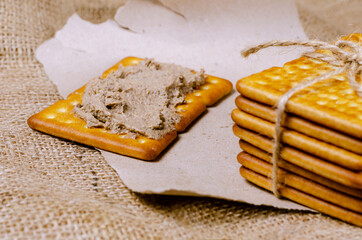 Rectangular liver pate crackers on a burlap sack.