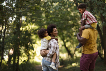 Walk trough park.  African American family having fun outdoors.