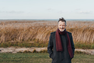 Fashionable man in smart overcoat and winter scarf