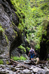 A hiker crossing a stream in the mountains
