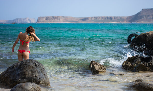 the girl in red bikini in the sea waves