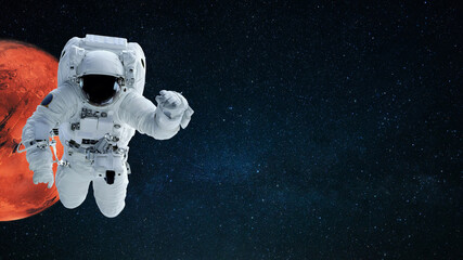 Space man in space suit flies in starry space with red planet mars, copy space for text and design....