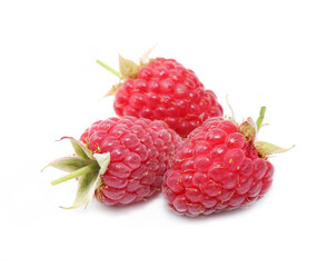 Three fresh ripe juicy raspberries with green tails isolated on a white background. Fresh healthy vegetarian food.