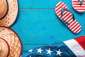 Summer in America, top view flat lay of USA flag, flip flops and sonoma straw beach hat