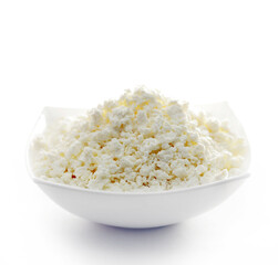 cottage cheese in a white bowl isolated on a white background.