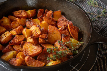 Cast iron pan with fried potatoes