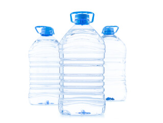 Three large plastic bottles of clean water for drinking, isolated on white background.