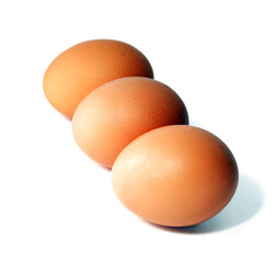 Three brown chicken eggs isolated on a white background.