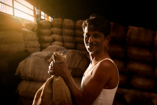 A FARMER WITH HIS PRODUCE AT A MANDI OR WHOLESALE MARKET	