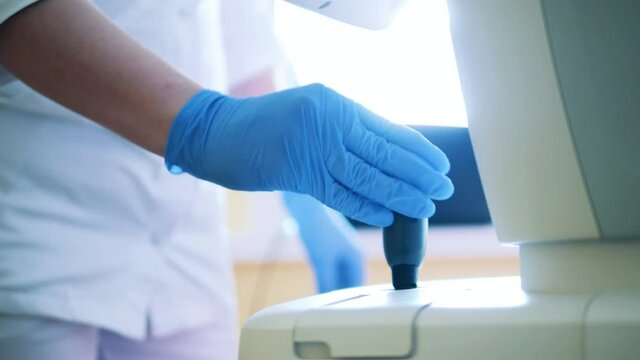 Specialist is operating a joystick of a medical device
