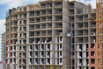 Fototapeta na wymiar High rise building under construction, empty premises without a front wall