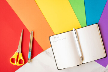 Notebook with phrases about the LGBT movement on various colored sheets representing the LGBT...