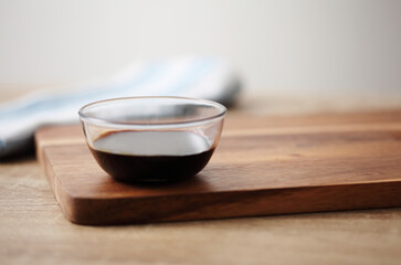 Chinese soy sauce in small cup on table