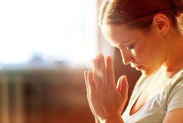 religion, faith and people concept - close up of woman meditating at yoga studio