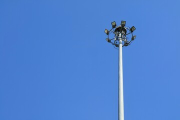 Street lights tower with clear blue sky background. Technology and nature concept.