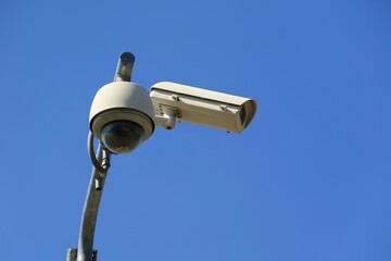 CCTV Security camera at public street in the city with blue sky background. Technology and outdoor concept.