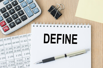 DEFINE word on a white notepad on an office table.