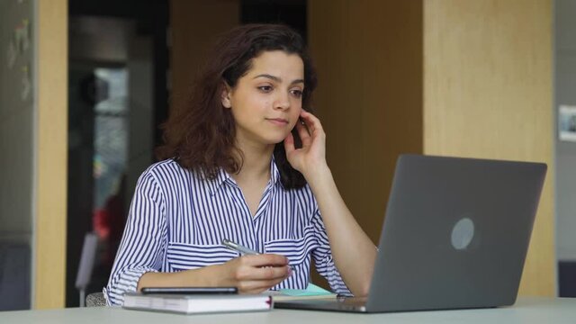 Happy latin hispanic girl college student, employee, customer support or sales manager having talk using laptop video conference calling virtual meeting at home or campus.