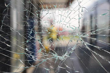 Glass broken cracks splinters in front of the bus station