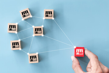 Franchise business concept,hand choose wood blog with franchise marketing.