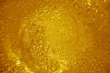 The water surface has a golden sponge as a blurred background.