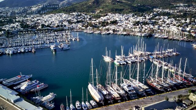 Amazing panoramic view from drone of beautiful full of yachts Bodrum harbour and ancient Kalesi castle in Mugla province in Turkey
