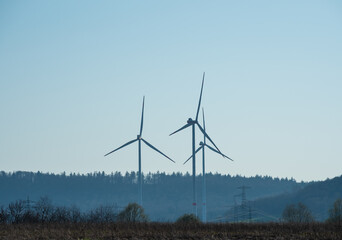 Windmills against blue sky in sunshine