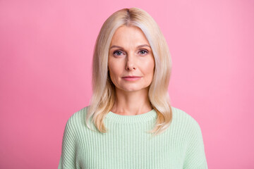 Photo of serious charming adorable lady pensioner wear green sweater isolated pink color background