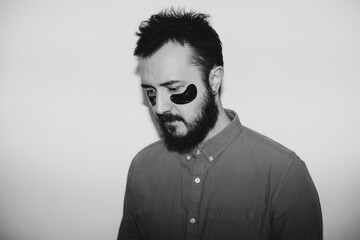 Handsome bearded hipster man with eye patch on the face. Stylish black and white photography