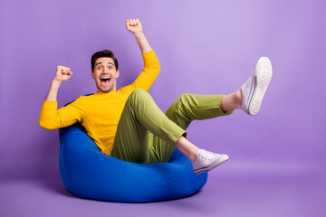 Full size profile photo of astonished man fists legs up open mouth celebrate isolated on violet...