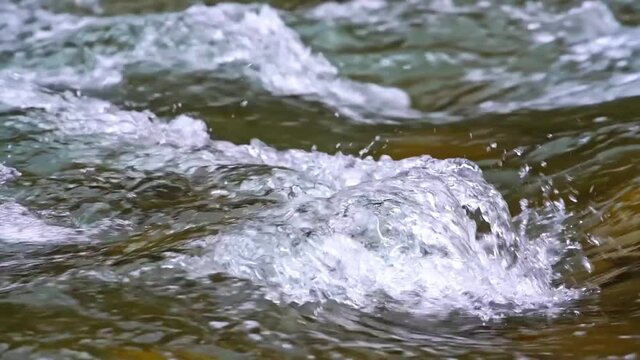 Tracking shot of gurgling water flowing