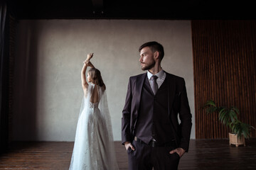 young groom and bride. stylish pair in a beautiful loft interior.